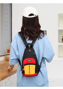Rear view of a colorful tricolor crossbody bag shown on a model in a cozy setting