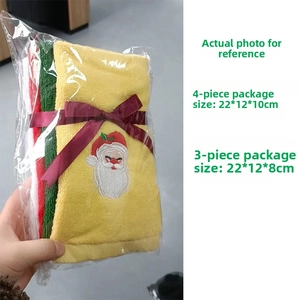 Detail of Christmas towels with Santa embroidery and festive ribbon packaging