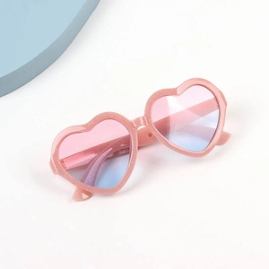 Close-up of kids heart sunglasses with pink glitter frames and gradient lenses