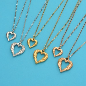 Three angel wing heart necklaces in silver gold and rose gold on a blue background