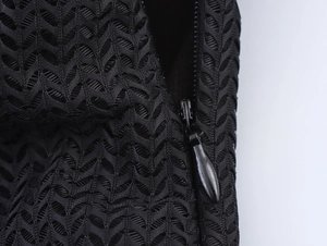 Detailed macro view of black mesh fabric and high-quality invisible zipper on the dress