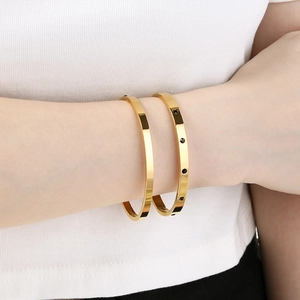 Elegant gold stainless steel open bangles set with black sparkling stones for women
