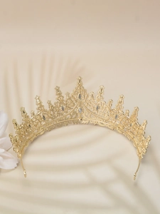 Close-up of gold princess crown with sparkling rhinestones and hollow metal craft detail