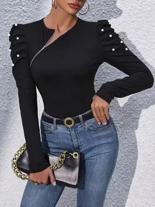 Elegant black long sleeve top with pearl bubble sleeves and asymmetrical zipper detail