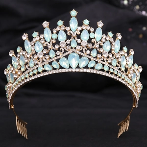 Detail of mint green crystals and rhinestones on a baroque gold bridal crown hair comb