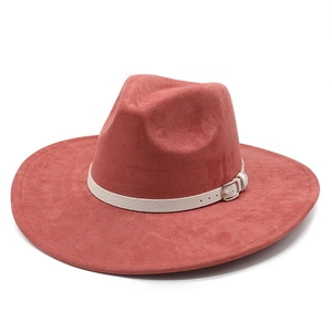 Detail of wide brim fedora hat in rose red suede with decorative white belt and metal buckle