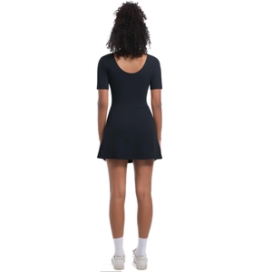 Back view of black short sleeve tennis dress featuring a deep round neck and A-line hem
