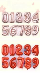 Detailed view of 32-inch foil balloons in rose gold and red for party backdrop decor