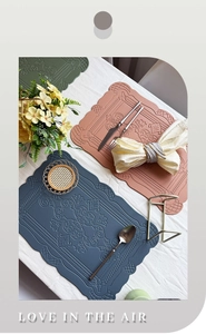 Close-up of embossed floral patterns on waterproof faux leather placemats in multiple colors