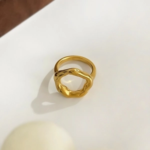 Macro shot of 18K gold plated hollow irregular ring with a liquid lava metal texture