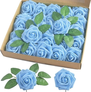 Close-up of light blue foam roses with green leaves in a kraft paper box for weddings