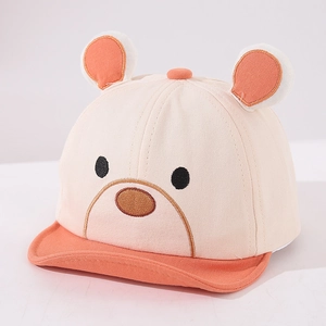 Detailed macro view of the soft cotton fabric and cute cartoon bear embroidery on baby cap