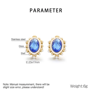 Detail view of oval blue glass earrings with shell beads and stainless steel frame