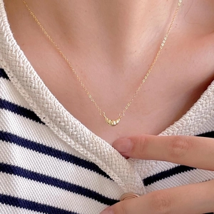 Minimalist 925 sterling silver croissant pendant necklace in gold worn by a model