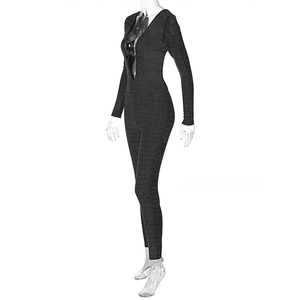 Close-up of shiny black long sleeve jumpsuit with deep V-neck and glitter fabric detail