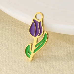 Macro detail of purple and green enamel tulip pendant charm with gold metal finish