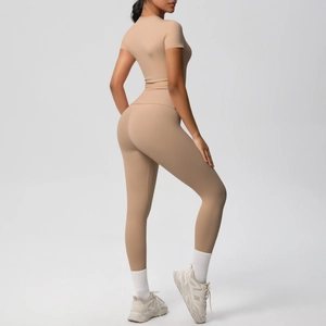 Side-back view of light tan high-stretch yoga set with short sleeve top and leggings