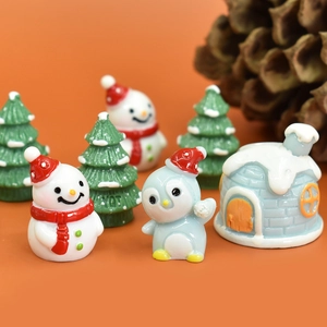 Christmas themed resin miniature set featuring snowman penguin and igloo figurines