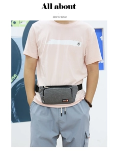 Close-up of gray sports waist bag with zipper pocket and adjustable belt on model