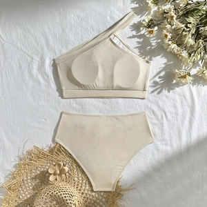 Detail of creamy white ribbed fabric on a one-shoulder bikini set for beach vacation