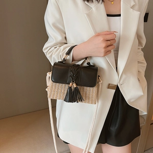 Chic straw woven crossbody bag with black leather flap and tassels for women