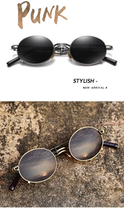 Detail of steampunk metal sunglasses with round dark lenses and punk style aesthetic