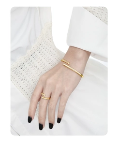 Close-up of golden S925 sterling silver bracelet and ring set with pearls and diamonds