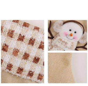 Close-up of knit texture and 3D snowman doll detail on festive Christmas stocking