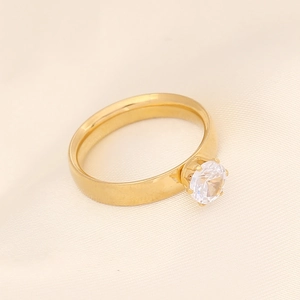 Vue macro d'une bague en acier doré avec un zircon cubique brillant serti à six griffes
