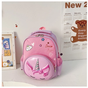 Detail of pink cartoon unicorn kids backpack with Dream Bigger embroidery and 3D bow