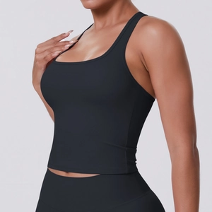 Detail view of black compression yoga tank top with wide straps and breathable fabric texture