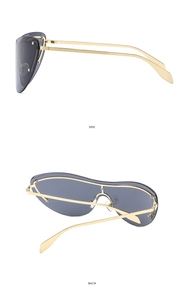 Detail view of cat eye rimless sunglasses with gold metal temples and grey lenses