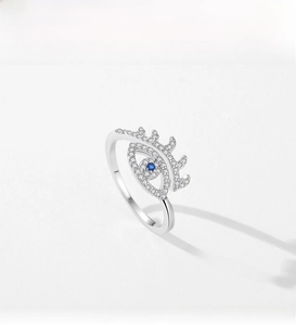 Macro detail of s925 silver evil eye ring with blue crystal and pave zircon eyelashes