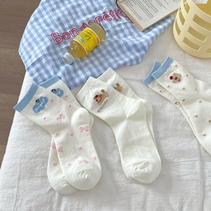 Detailed view of three pairs of cute Japanese-style cartoon socks with animal patterns