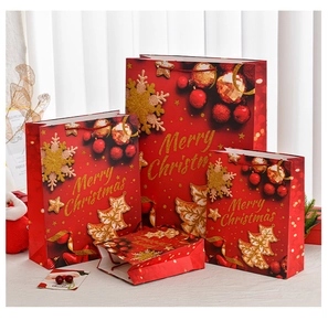 Detail of red Christmas gift bags in various sizes with golden Merry Christmas text