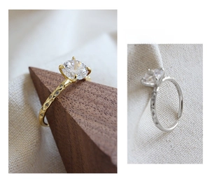 Detailed close-up of S925 sterling silver four-prong round zircon ring with hollow band