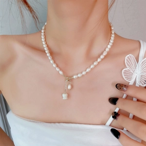 Detailed view of freshwater pearl necklace with white tulip and teardrop pearl pendant