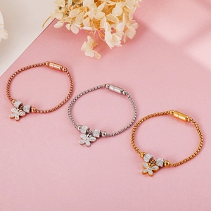Detailed macro view of crystal butterfly charm bracelets with magnetic clasp in three colors