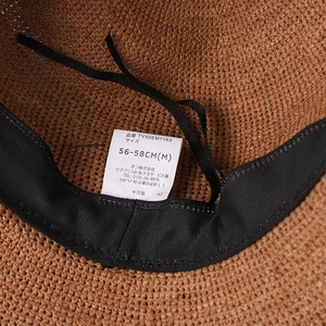 Detail of adjustable sweatband and sizing label inside the raffia sun hat
