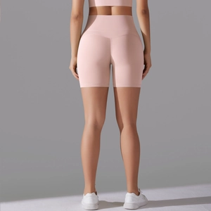 Close-up of pink high-waisted yoga shorts with seamless back showing contouring stitch lines