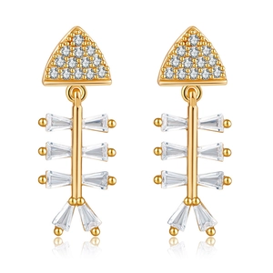 Macro view of gold plated fishbone earrings featuring sparkling cubic zirconia crystals