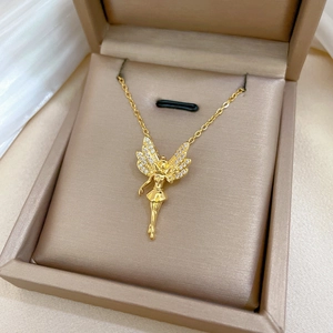 Macro shot of a golden butterfly fairy pendant with rhinestones in a gift box