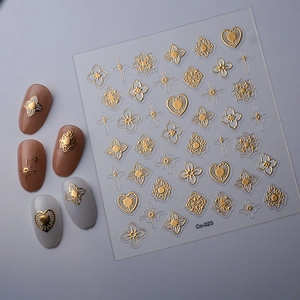 Macro view of gold embossed geometric nail stickers with star and heart patterns