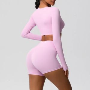 Detail view of pink long sleeve yoga top and high waist shorts set for fitness training
