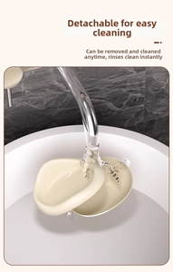 Cream cloud soap dish with detachable design being rinsed under tap water for easy cleaning