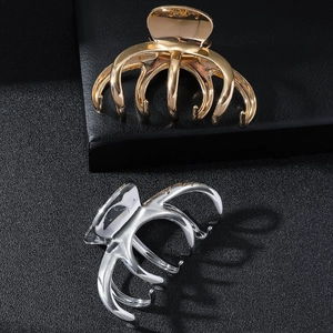 Elegant gold and silver metal shark hair clips for thick hair on black background