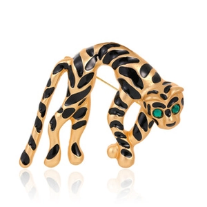 Detail view of leopard brooch with gold metal, black enamel and green rhinestone eyes
