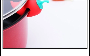 Macro shot of a red chili-shaped silicone lid lifter and steam releaser for pots