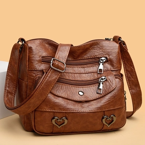 Brown multi-pocket faux leather crossbody bag with heart hardware and adjustable strap