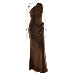 Detail of brown satin off-shoulder fisheye dress showing pleated texture and glossy finish